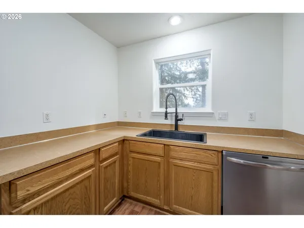 a kitchen with a sink and a window