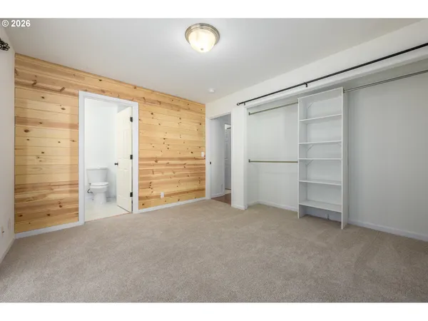a view of an empty room with cabinet and a window