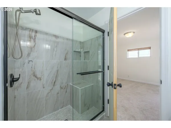 a bathroom with a glass shower door