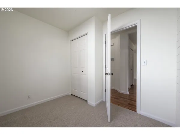 a bathroom with a toilet a sink a mirror and vanity