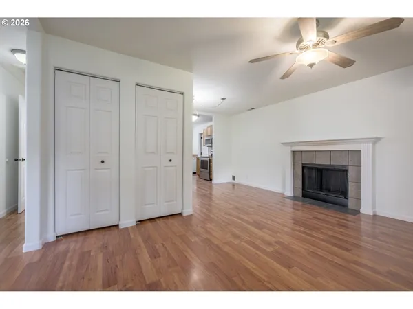 a view of an empty room with wooden floor