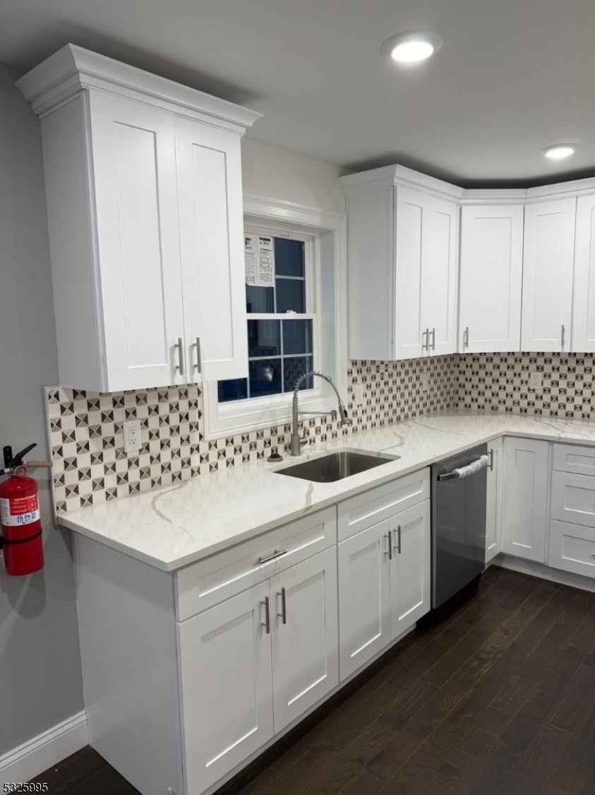 7 Maple Street Bloomfield, NJ 07003 - Photo 4 of 14 a kitchen with granite countertop white cabinets and white appliances