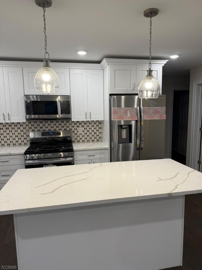 7 Maple Street Bloomfield, NJ 07003 - Photo 5 of 14 a kitchen with a refrigerator and a chandelier