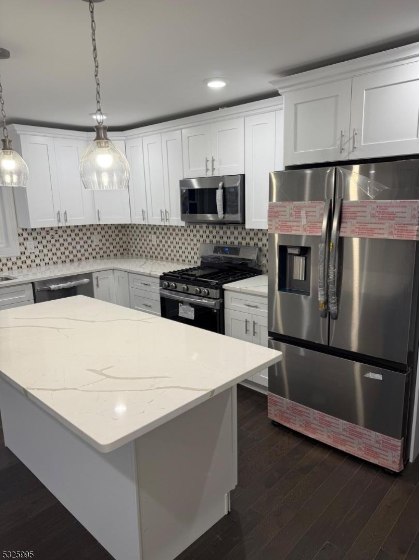 7 Maple Street Bloomfield, NJ 07003 - Photo 6 of 14 a kitchen with a sink a microwave a stove and refrigerator