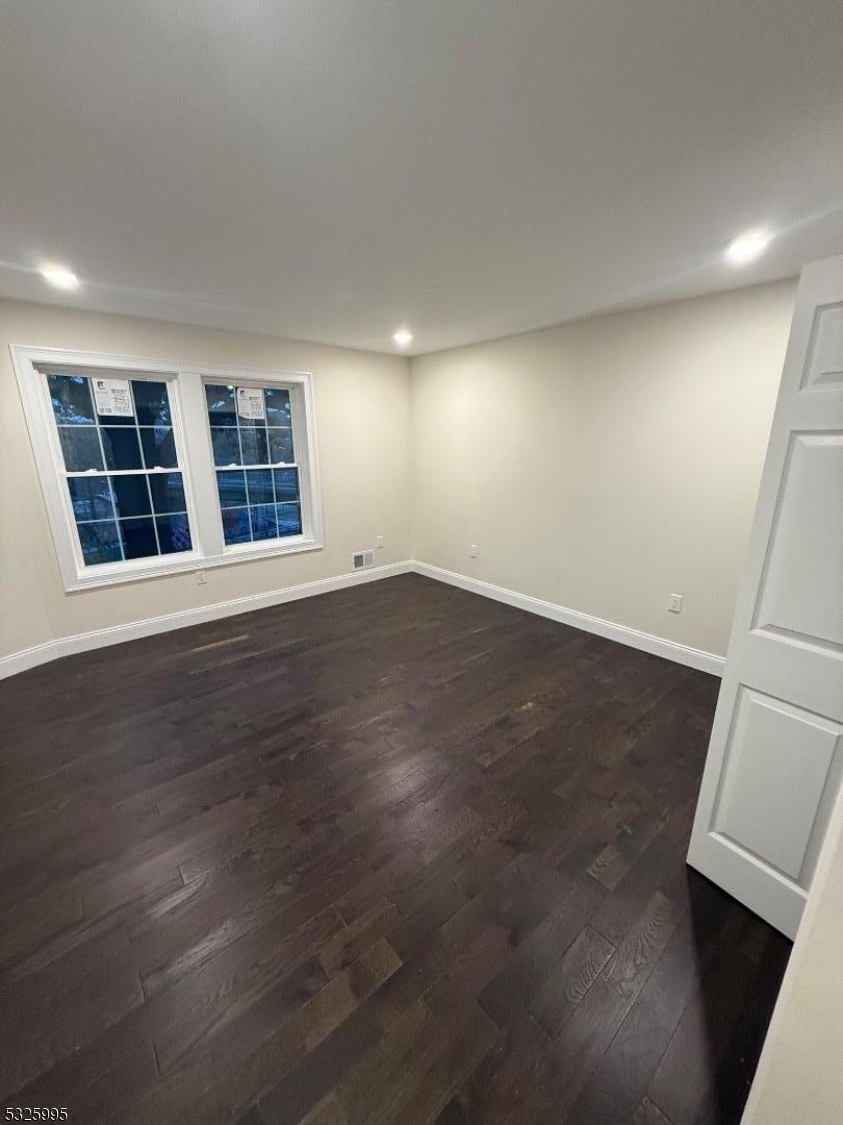 7 Maple Street Bloomfield, NJ 07003 - Photo 8 of 14 an empty room with wooden floor and windows