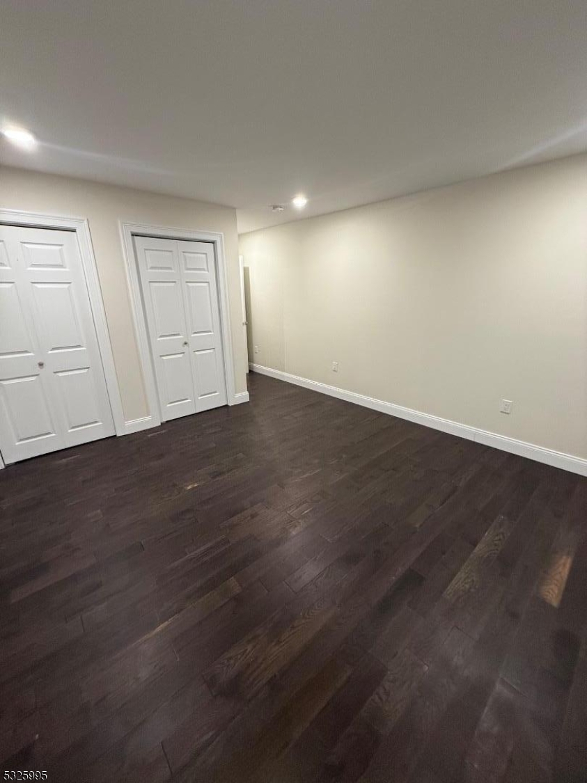 7 Maple Street Bloomfield, NJ 07003 - Photo 9 of 14 an empty room with wooden floor and windows
