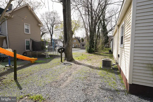 a view of a backyard with a tree