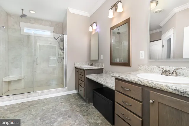 a bathroom with a granite countertop sink mirror and shower
