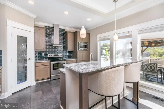 a kitchen with stainless steel appliances granite countertop a stove and cabinets
