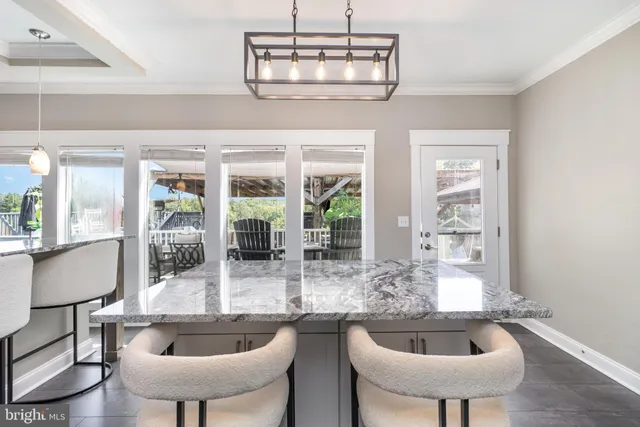 a dining room with furniture a chandelier and window