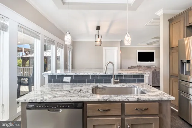 a kitchen with granite countertop a sink and a counter top space