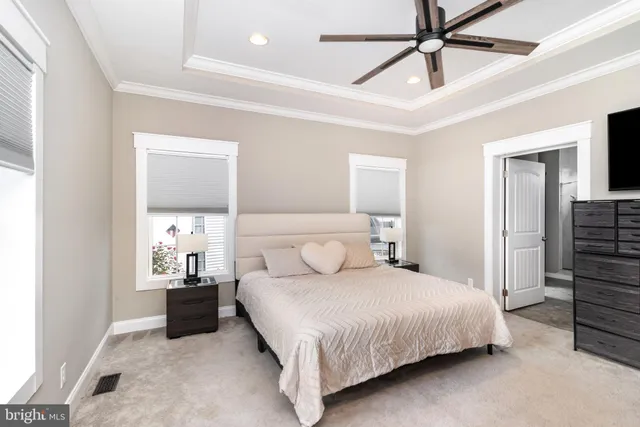 a bedroom with a bed and ceiling fan