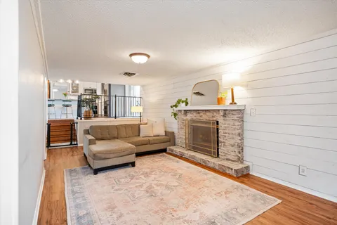 a living room with furniture and a fireplace