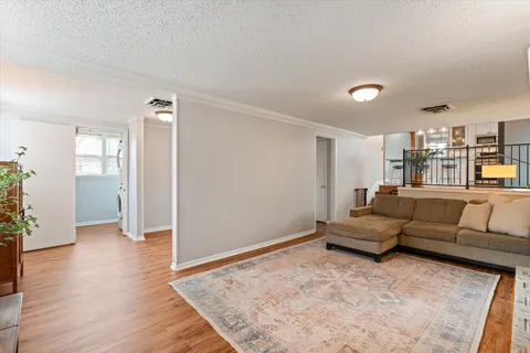 a living room with furniture and wooden floor