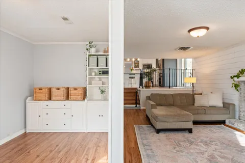 a living room with furniture and a book shelf
