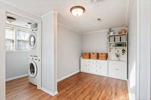 a view of a kitchen with fridge and wooden floor