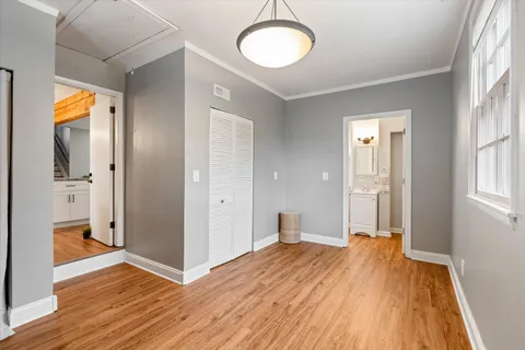a view of a room with wooden floor and window