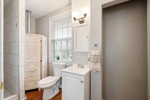 a bathroom with a sink toilet and shower