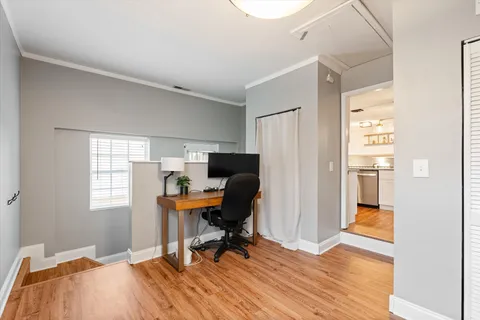 a workspace with wooden floor and a window