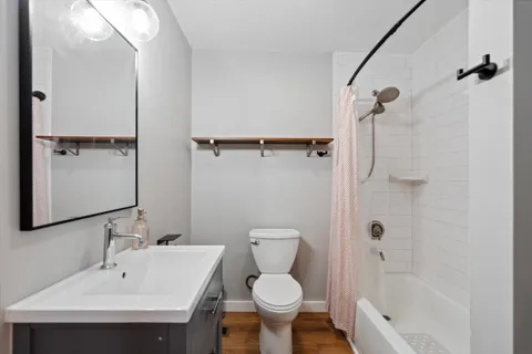 a bathroom with a sink toilet and shower