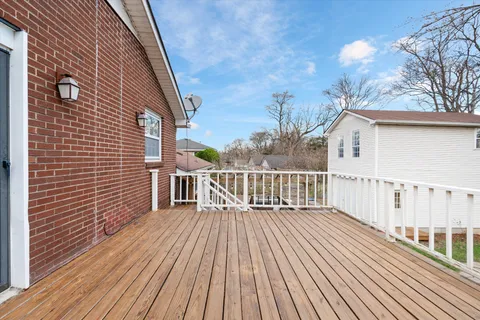 a view of a wooden deck with a yard