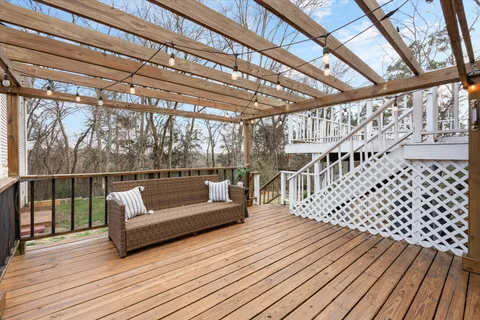 a roof deck with couches and wooden floor