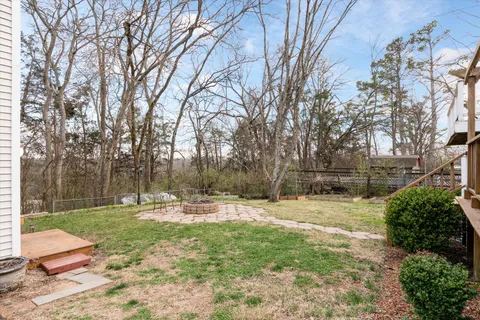 a backyard of a house with lots of green space and fountain