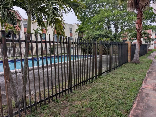 a view of a backyard with wooden fence