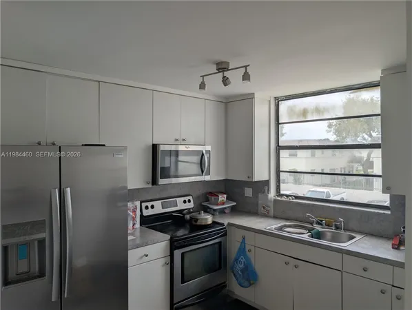 a kitchen with a sink stove and refrigerator