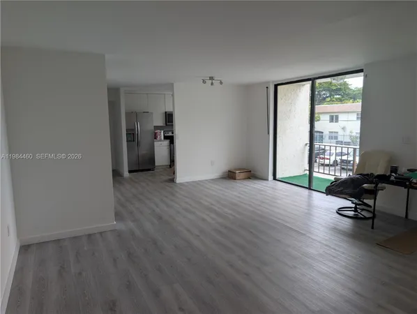 a view of a livingroom with furniture and a window