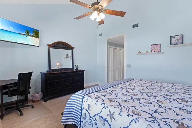 a bedroom with a bed and a dresser in it