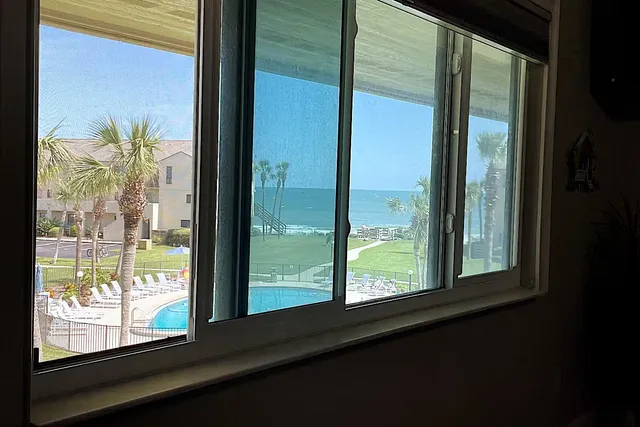 a view of a glass door and a window