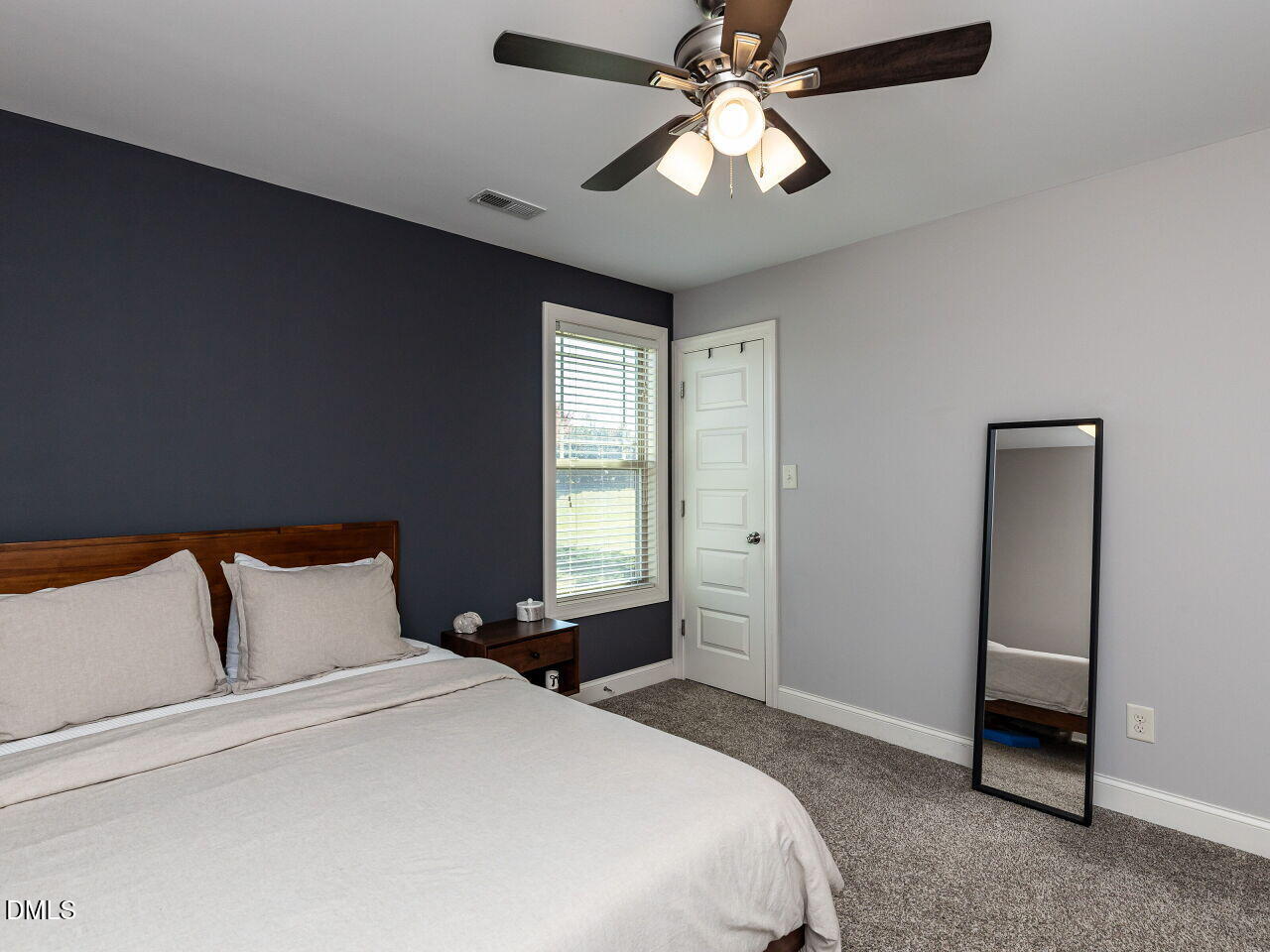 742 Adams Point Drive Garner, NC 27529 - Photo 23 of 31 a bedroom with a large bed and a chandelier