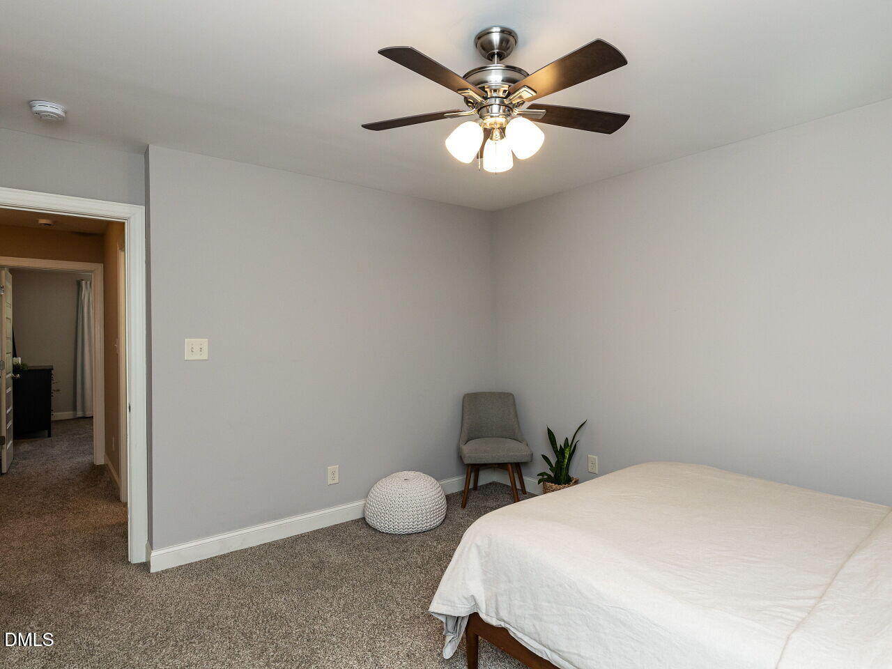 742 Adams Point Drive Garner, NC 27529 - Photo 24 of 31 a bedroom with a bed and a chandelier