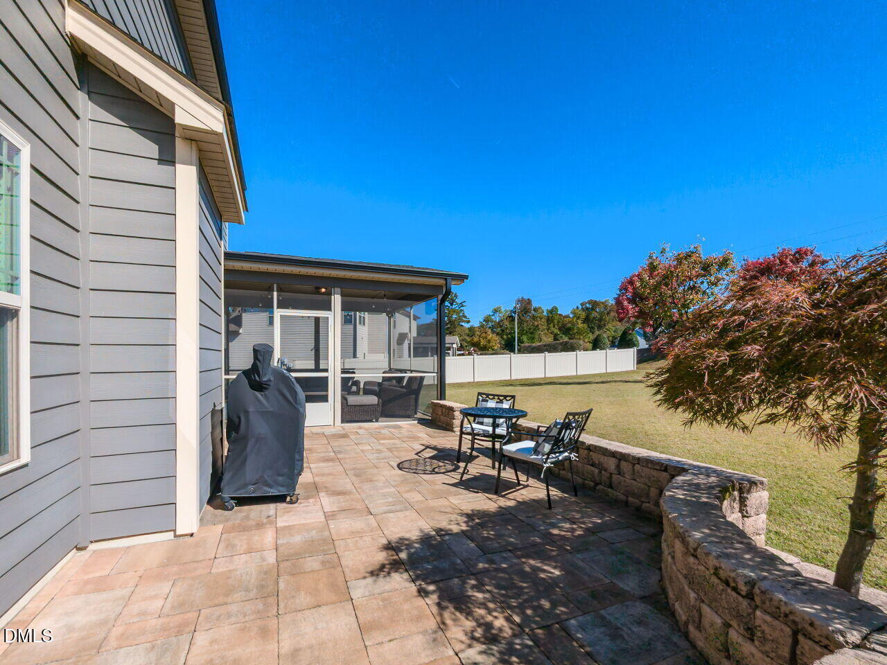 742 Adams Point Drive Garner, NC 27529 - Photo 29 of 31 a view of a patio with table and chairs and a barbeque