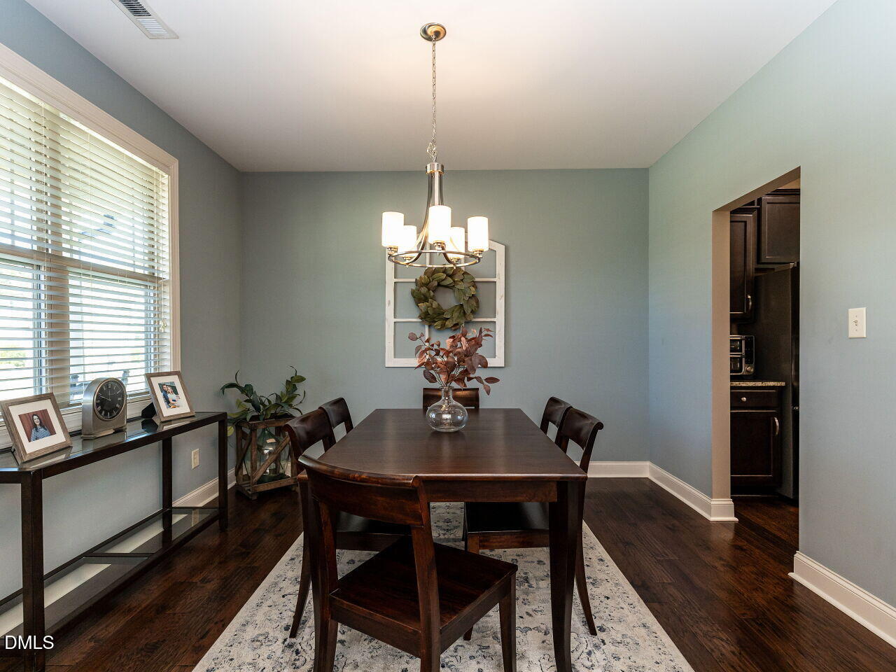 742 Adams Point Drive Garner, NC 27529 - Photo 4 of 31 a view of a dining room with furniture window and wooden floor