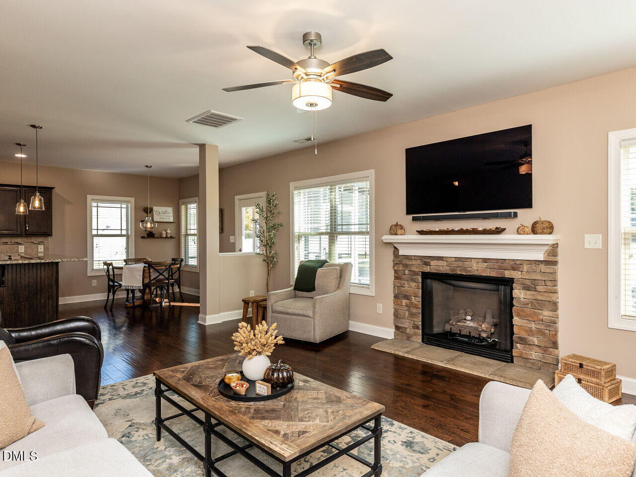 742 Adams Point Drive Garner, NC 27529 - Photo 10 of 31 a living room with furniture a flat screen tv and a fireplace