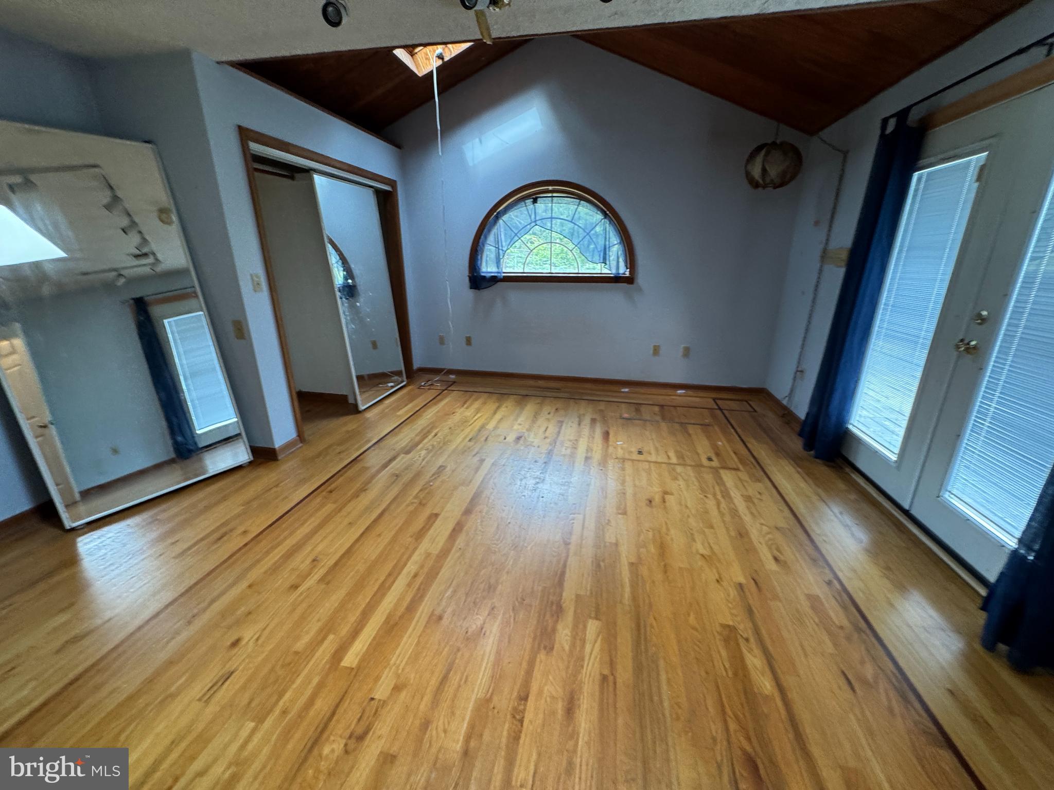 8922 Carpers Pike Yellow Spring, WV 26865 - Photo 17 of 23 a view of an empty room with wooden floor and a window