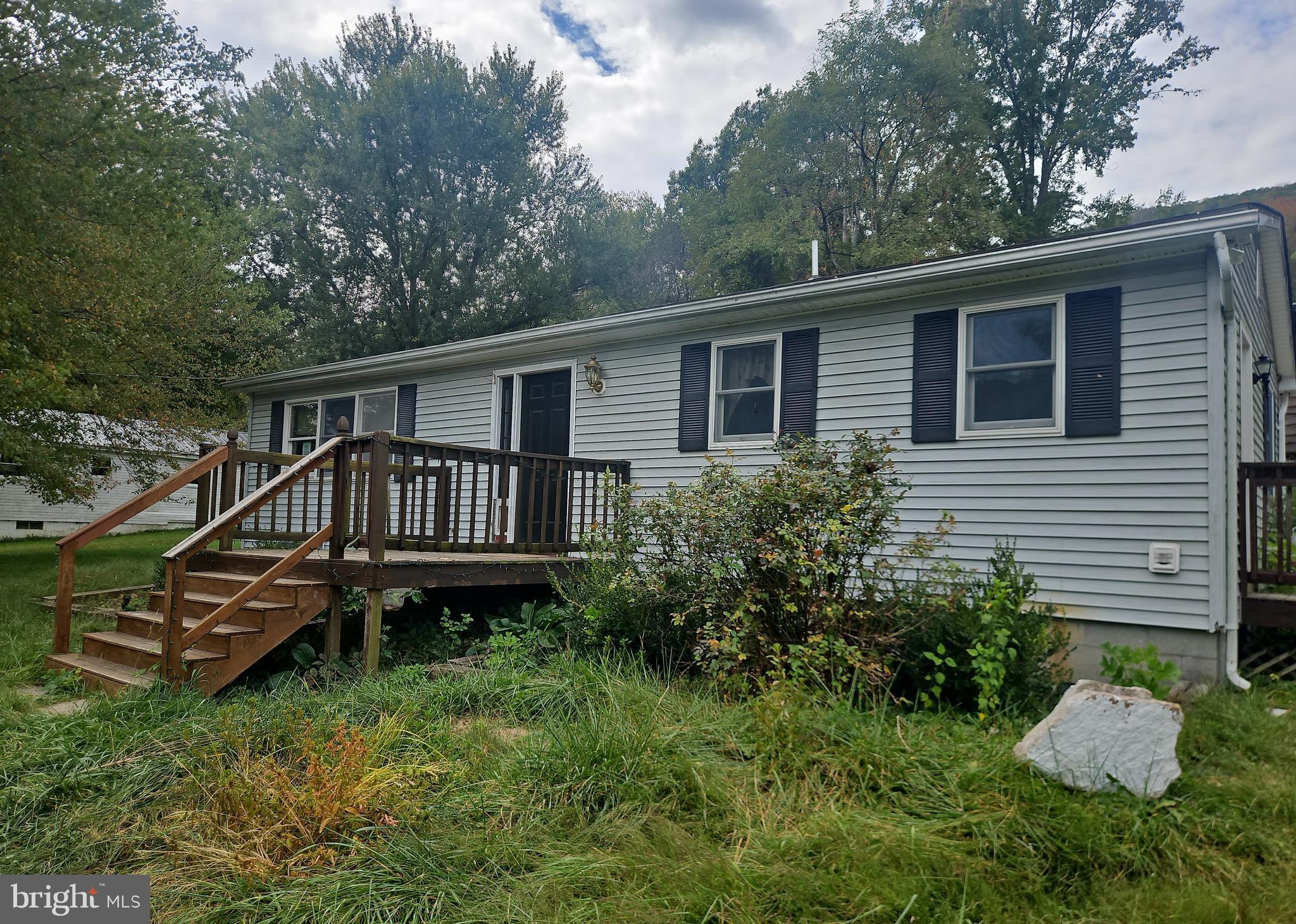 8922 Carpers Pike Yellow Spring, WV 26865 - Photo 2 of 23 a view of a house with a deck and a yard