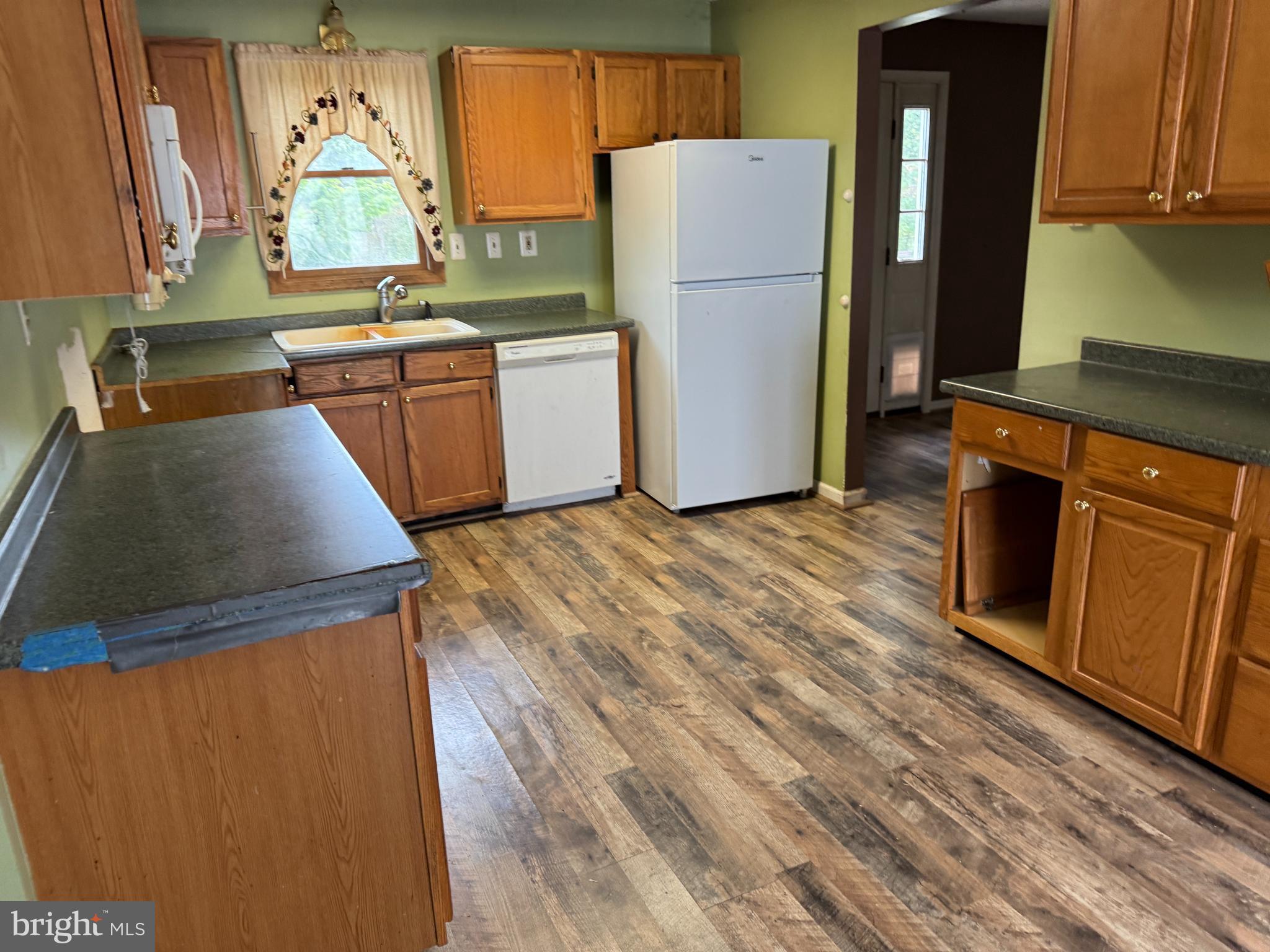 8922 Carpers Pike Yellow Spring, WV 26865 - Photo 6 of 23 a kitchen with sink a refrigerator and window