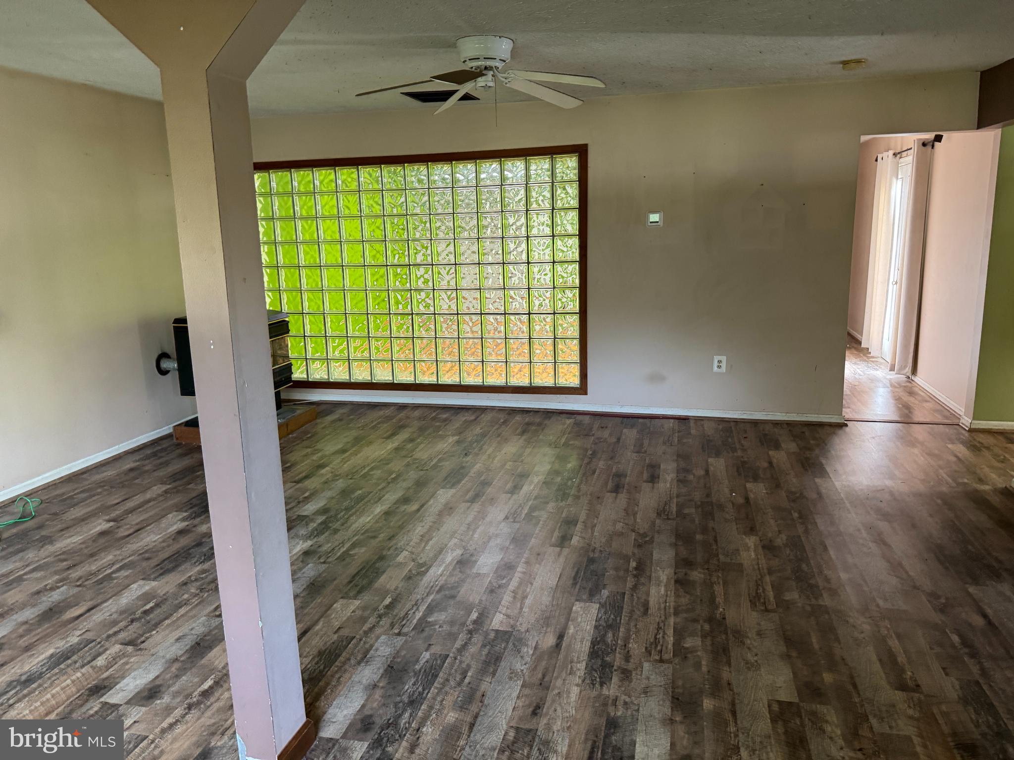 8922 Carpers Pike Yellow Spring, WV 26865 - Photo 10 of 23 a view of an empty room with wooden floor and a window