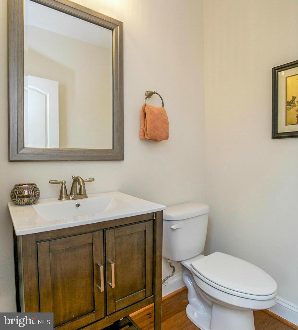 12504 Regwood Road Hydes, MD 21082 - Photo 12 of 28 a bathroom with a toilet a sink and mirror