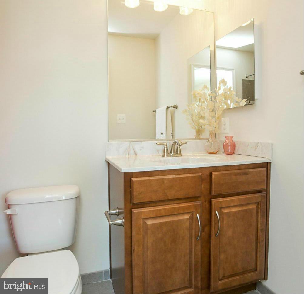12504 Regwood Road Hydes, MD 21082 - Photo 23 of 28 a bathroom with a toilet sink and mirror