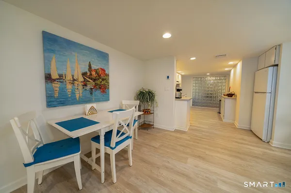 a view of a dining room with furniture and wooden floor