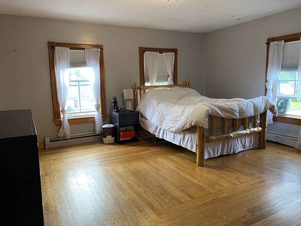 49-51 North Street Three Rivers, MA 01080 - Photo 13 of 21 a spacious bedroom with a bed and window
