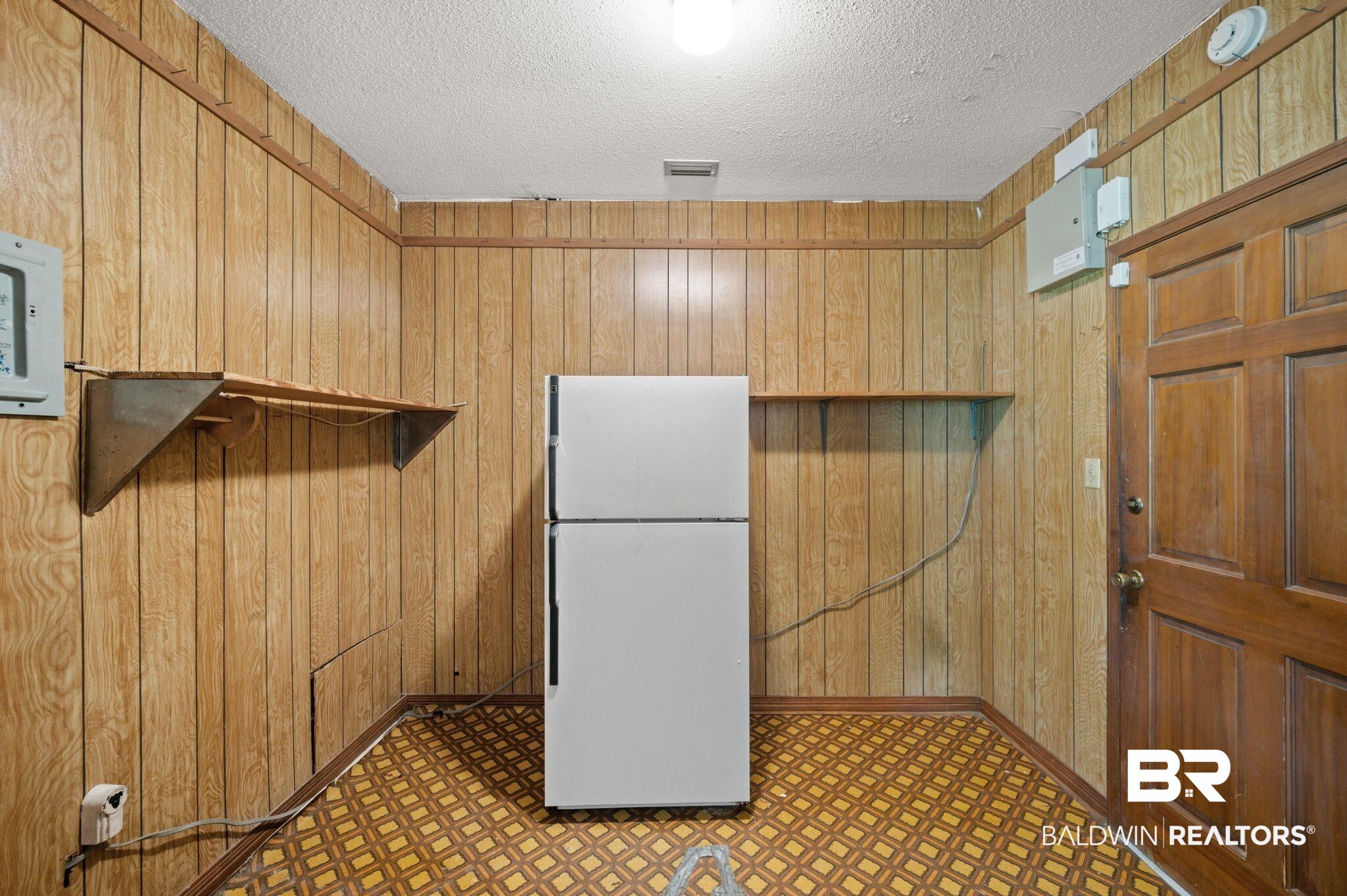 15880 Pine Grove Rd Extension West Bay Minette, AL 36507 - Photo 18 of 44 Interior space featuring white fridge, a textured ceiling, and wooden walls