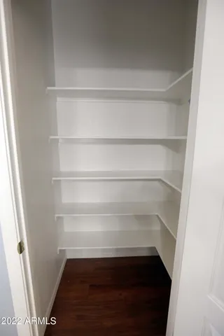 a view of walk in closet with empty racks