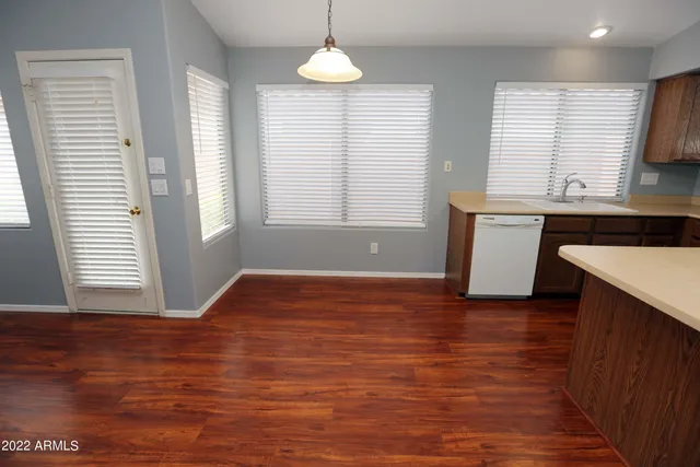 a view of kitchen with granite countertop window and wooden floor