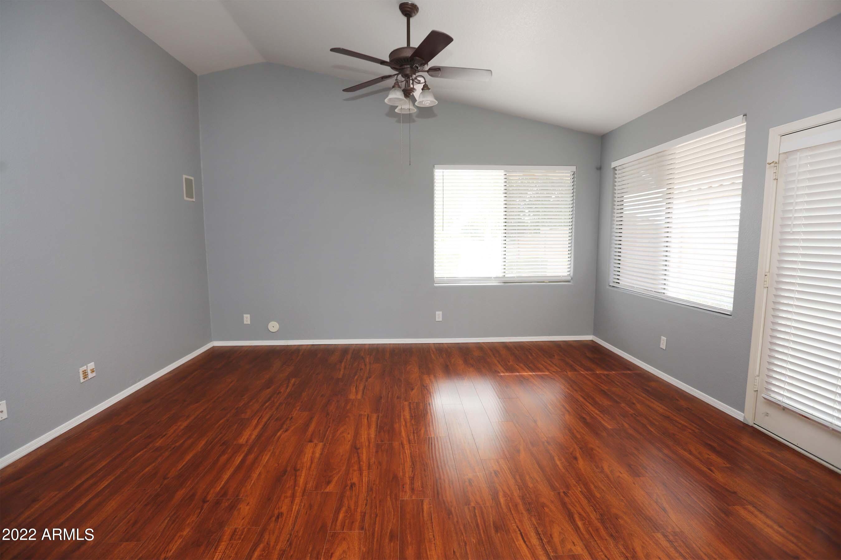 11217 West Edgemont Avenue Avondale, AZ 85392 - Photo 15 of 47 an empty room with wooden floor and windows