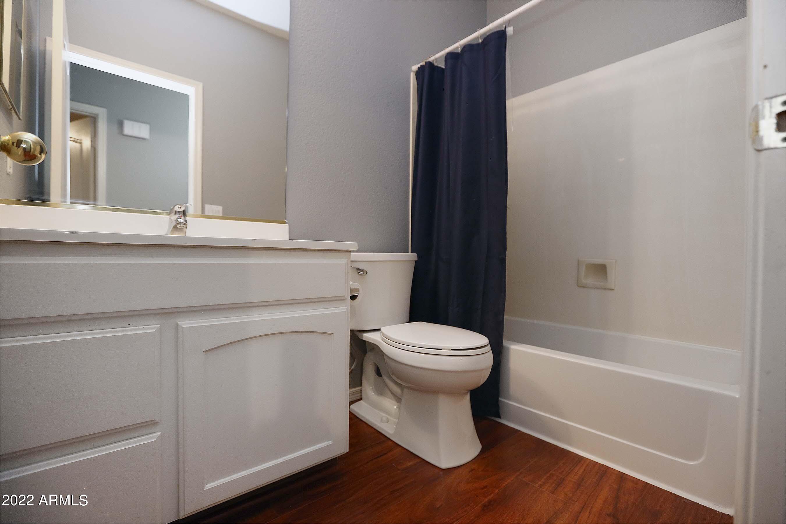 11217 West Edgemont Avenue Avondale, AZ 85392 - Photo 19 of 47 a bathroom with a toilet a sink and bathtub